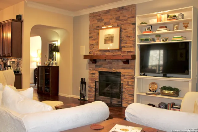 a living room with furniture flat screen tv and a fireplace