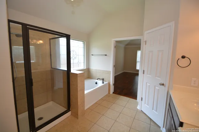 a bathroom with a glass door shower a sink and a mirror
