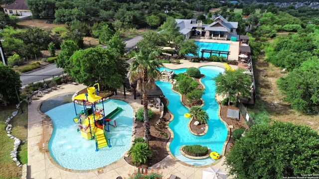 an aerial view of a house with a swimming pool outdoor seating