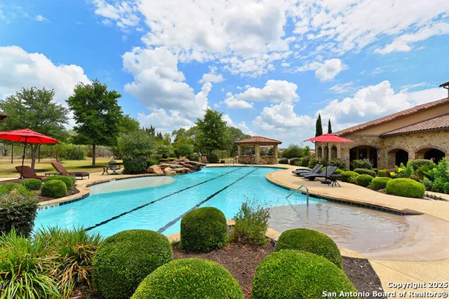 a view of a house with pool and chairs
