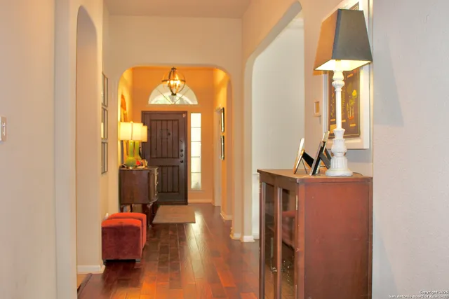 a hallway with furniture and a mirror