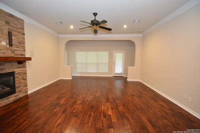 a view of a room with wooden floors and fireplace