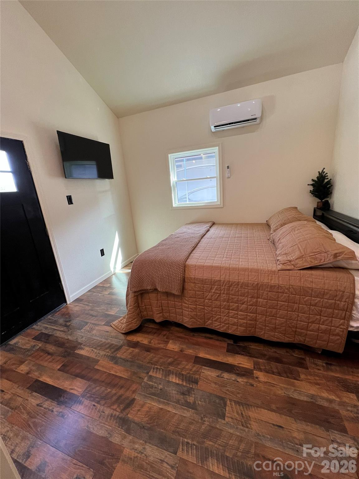 415 Hyde Road, Unit 24 Robbinsville, NC 28771 - Photo 12 of 47 a bedroom with a bed and a flat screen tv