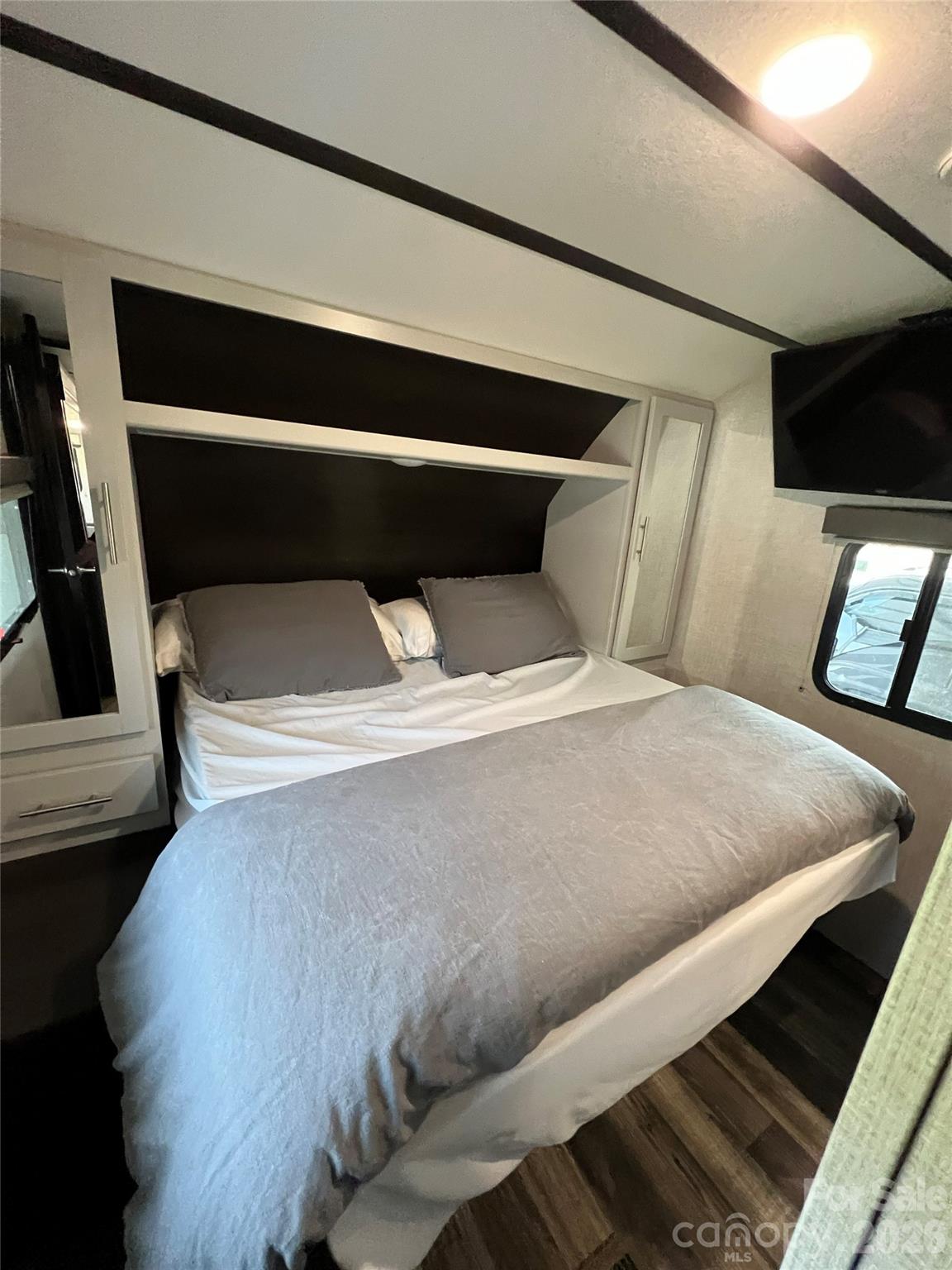 415 Hyde Road, Unit 24 Robbinsville, NC 28771 - Photo 14 of 47 a bed sitting in a bedroom next to a window