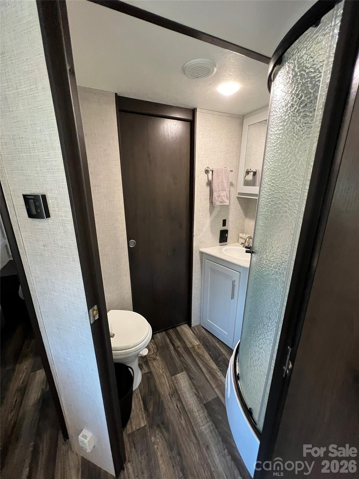 415 Hyde Road, Unit 24 Robbinsville, NC 28771 - Photo 17 of 47 a bathroom with a sink and mirror with toilet