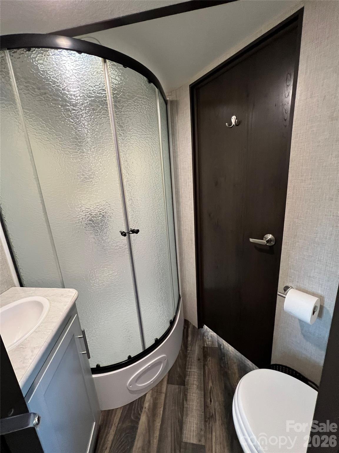 415 Hyde Road, Unit 24 Robbinsville, NC 28771 - Photo 19 of 47 a bathroom with a granite countertop sink toilet and shower