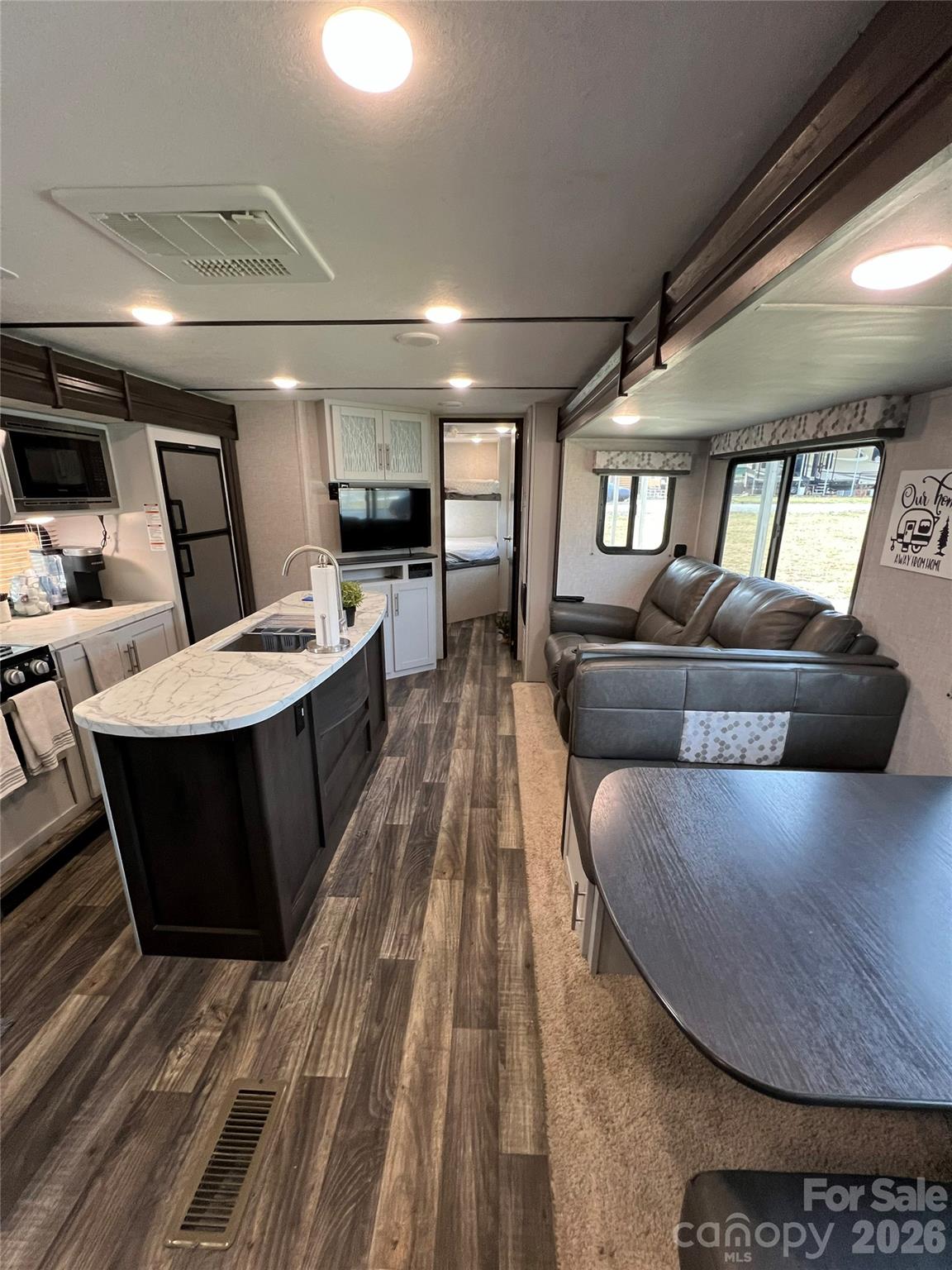 415 Hyde Road, Unit 24 Robbinsville, NC 28771 - Photo 20 of 47 a living room with a couch and a wooden floor