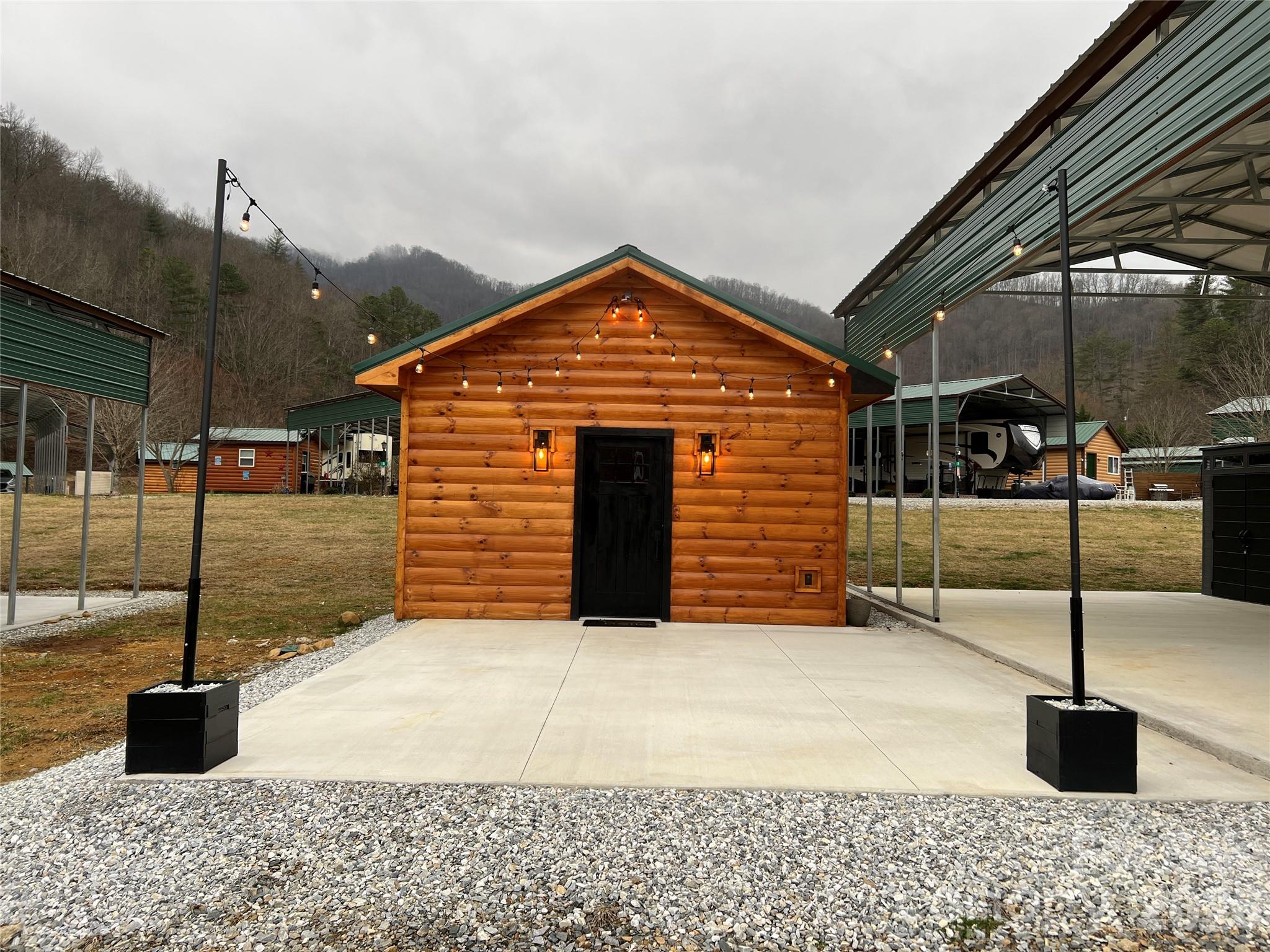 415 Hyde Road, Unit 24 Robbinsville, NC 28771 - Photo 2 of 47 a front view of a house with parking