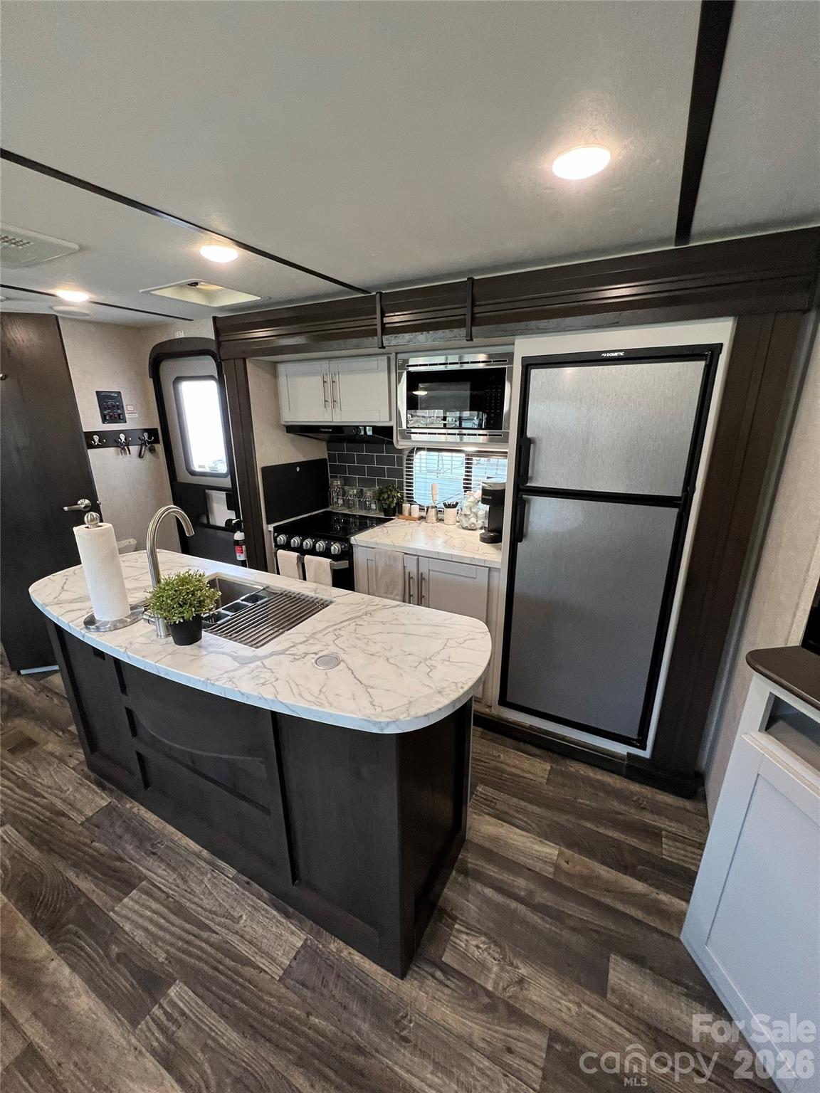 415 Hyde Road, Unit 24 Robbinsville, NC 28771 - Photo 22 of 47 a room with table chairs and stainless steel appliances