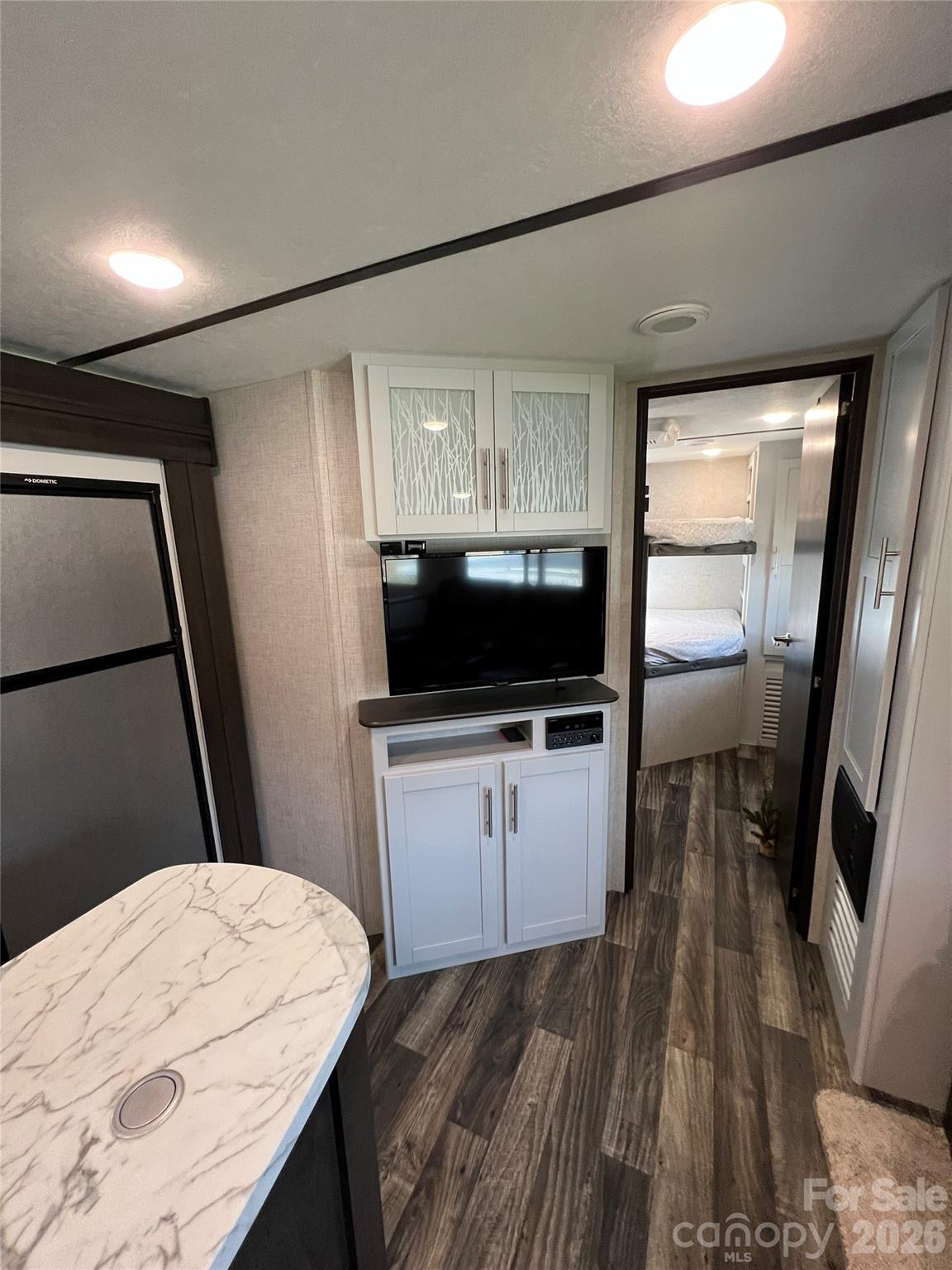 415 Hyde Road, Unit 24 Robbinsville, NC 28771 - Photo 23 of 47 a bedroom with a bed and a flat screen tv