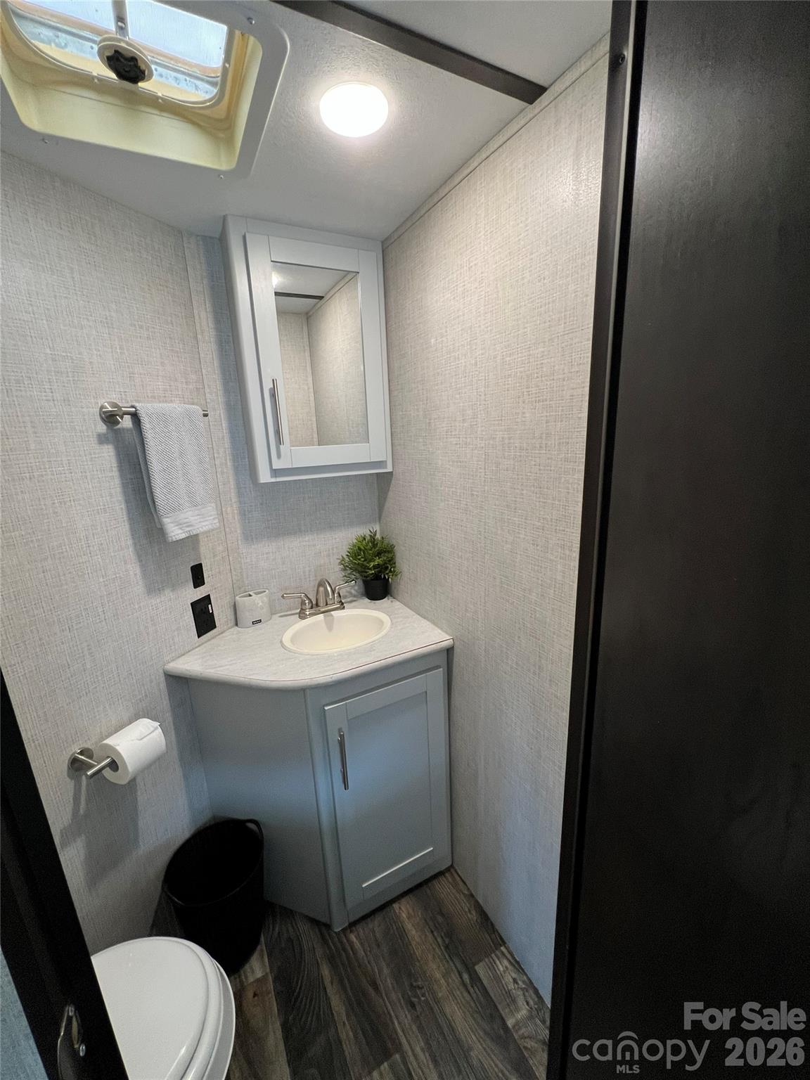 415 Hyde Road, Unit 24 Robbinsville, NC 28771 - Photo 26 of 47 a bathroom with a sink toilet and mirror