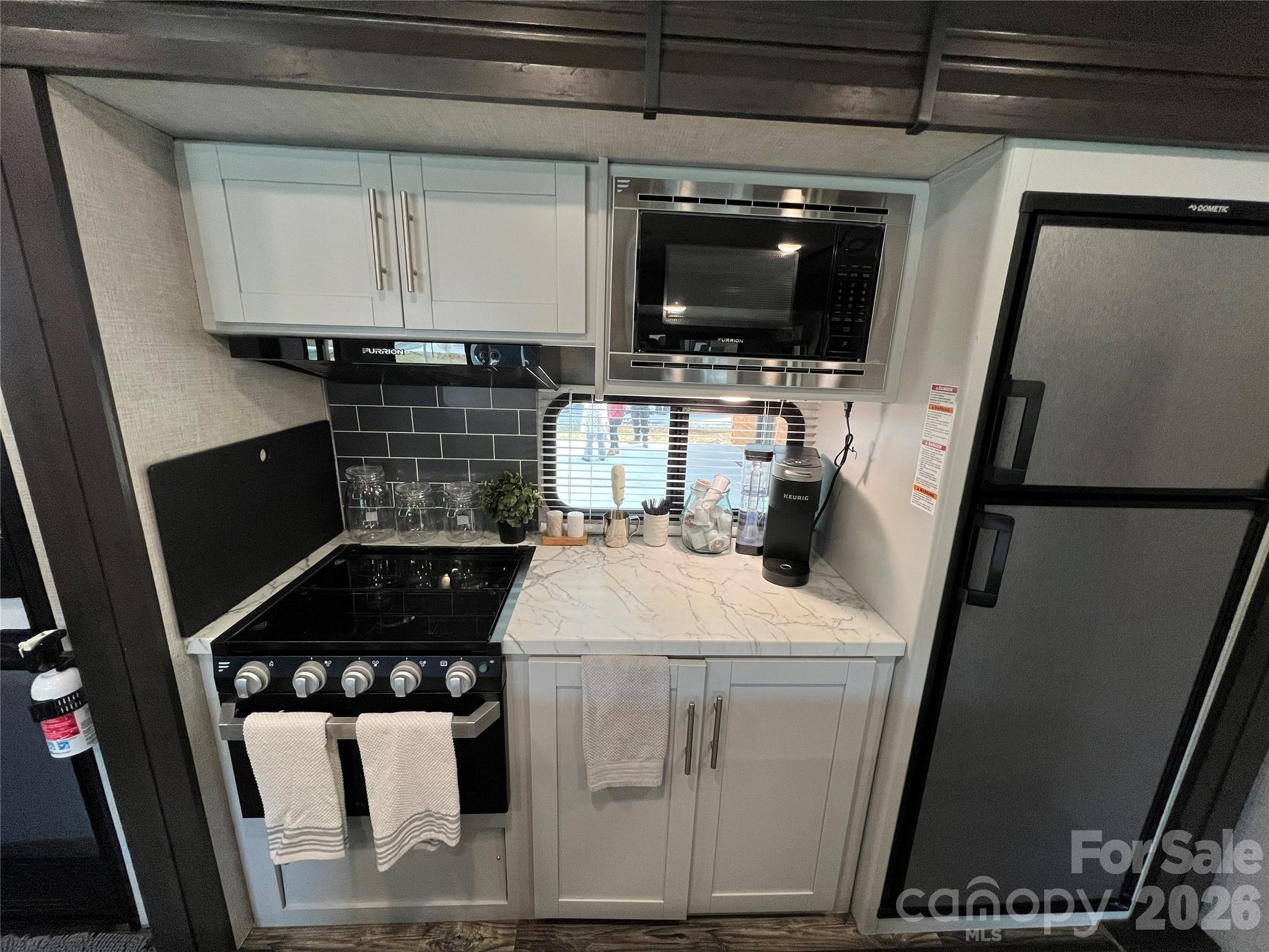 415 Hyde Road, Unit 24 Robbinsville, NC 28771 - Photo 32 of 47 a kitchen with a sink appliances and cabinets