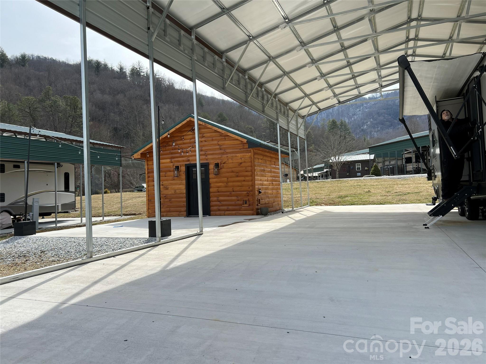 415 Hyde Road, Unit 24 Robbinsville, NC 28771 - Photo 4 of 47 a house with trees in front of it