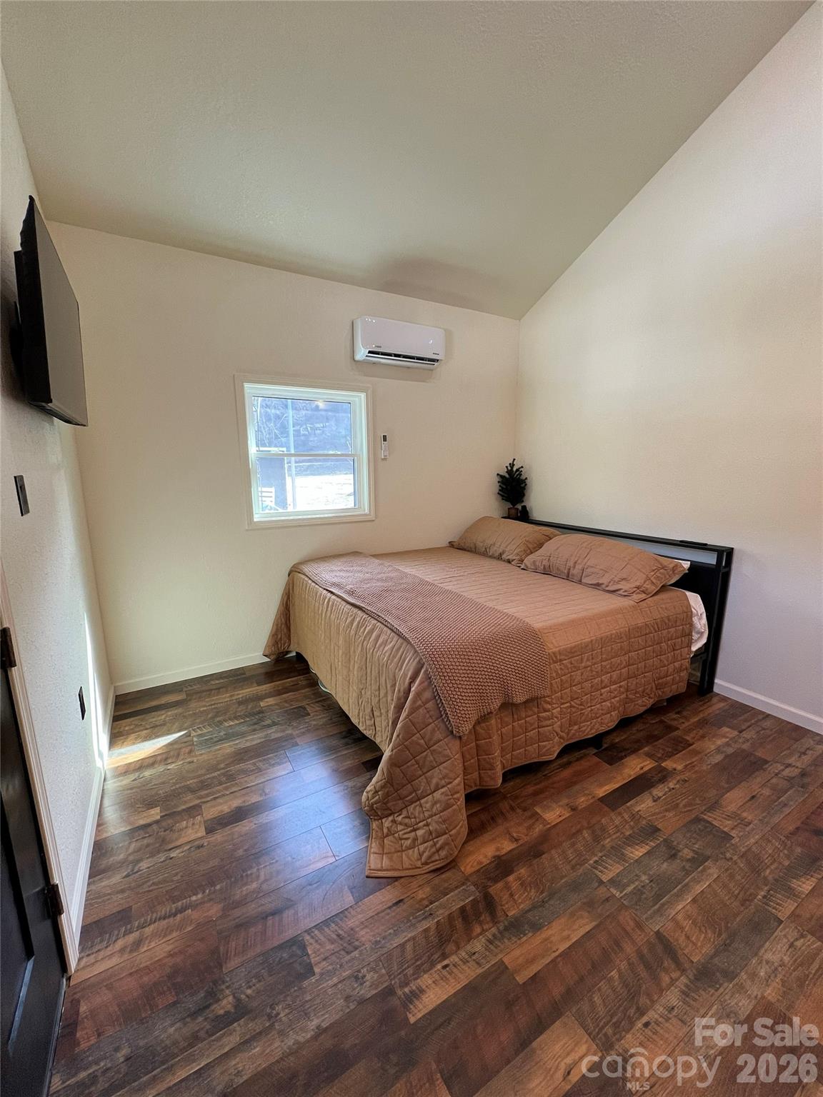 415 Hyde Road, Unit 24 Robbinsville, NC 28771 - Photo 8 of 47 a bedroom with a bed and flat screen tv