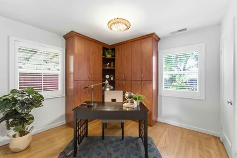 a view of a workspace with furniture and a potted plant