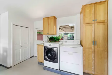 a utility room with window washer and dryer