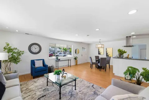 a living room with furniture a rug and a table