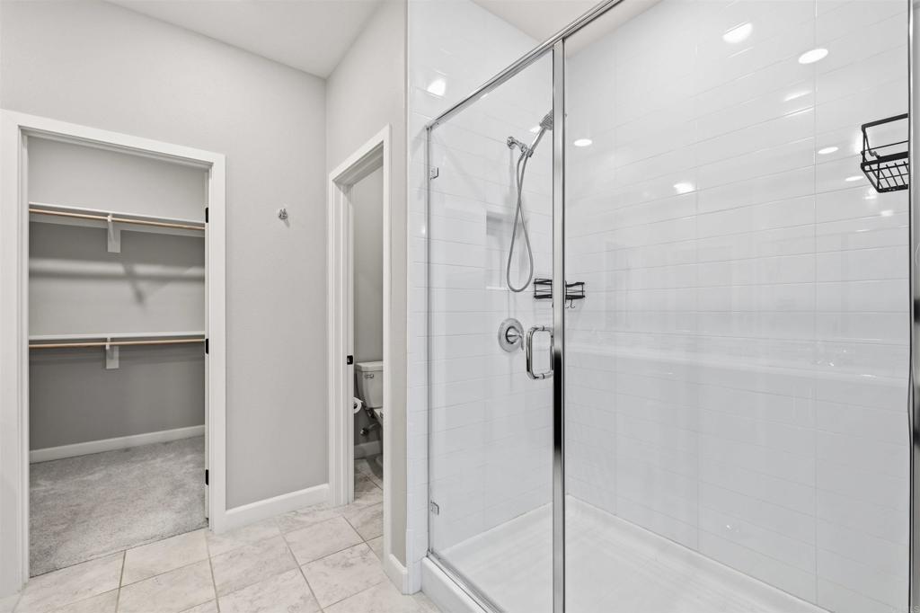 1118 Delpy View Vista, CA 92084 - Photo 17 of 32 a bathroom with a shower and a glass door