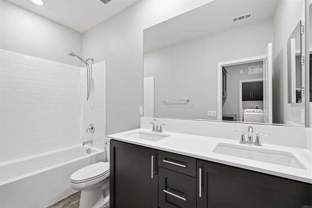 1118 Delpy View Vista, CA 92084 - Photo 21 of 32 a bathroom with a sink a toilet and shower