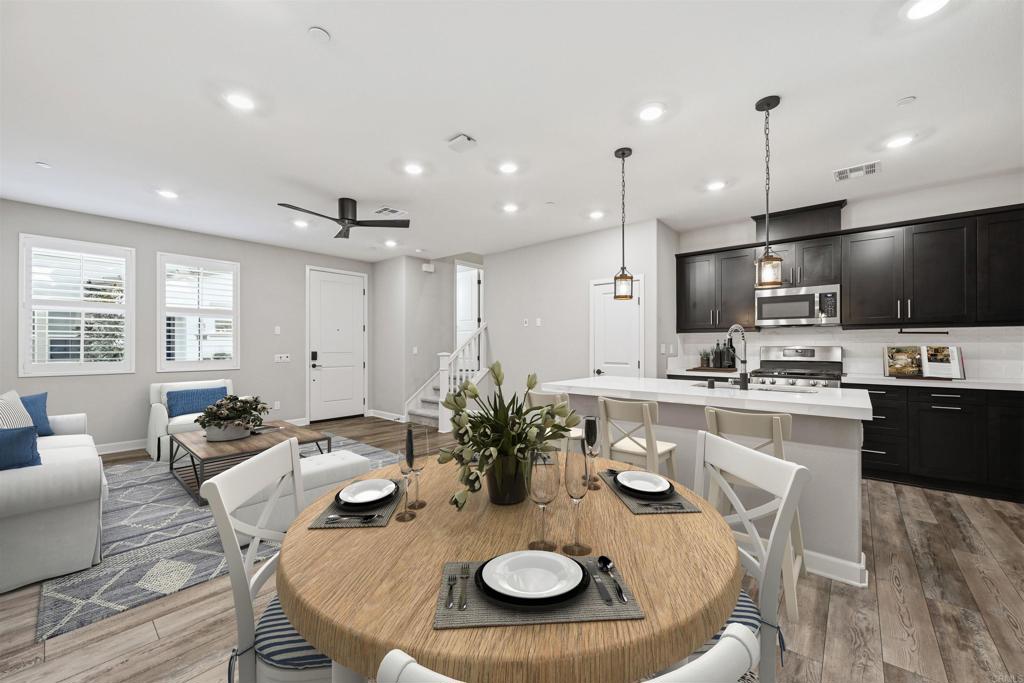 1118 Delpy View Vista, CA 92084 - Photo 9 of 32 a kitchen with sink refrigerator dining table and chairs