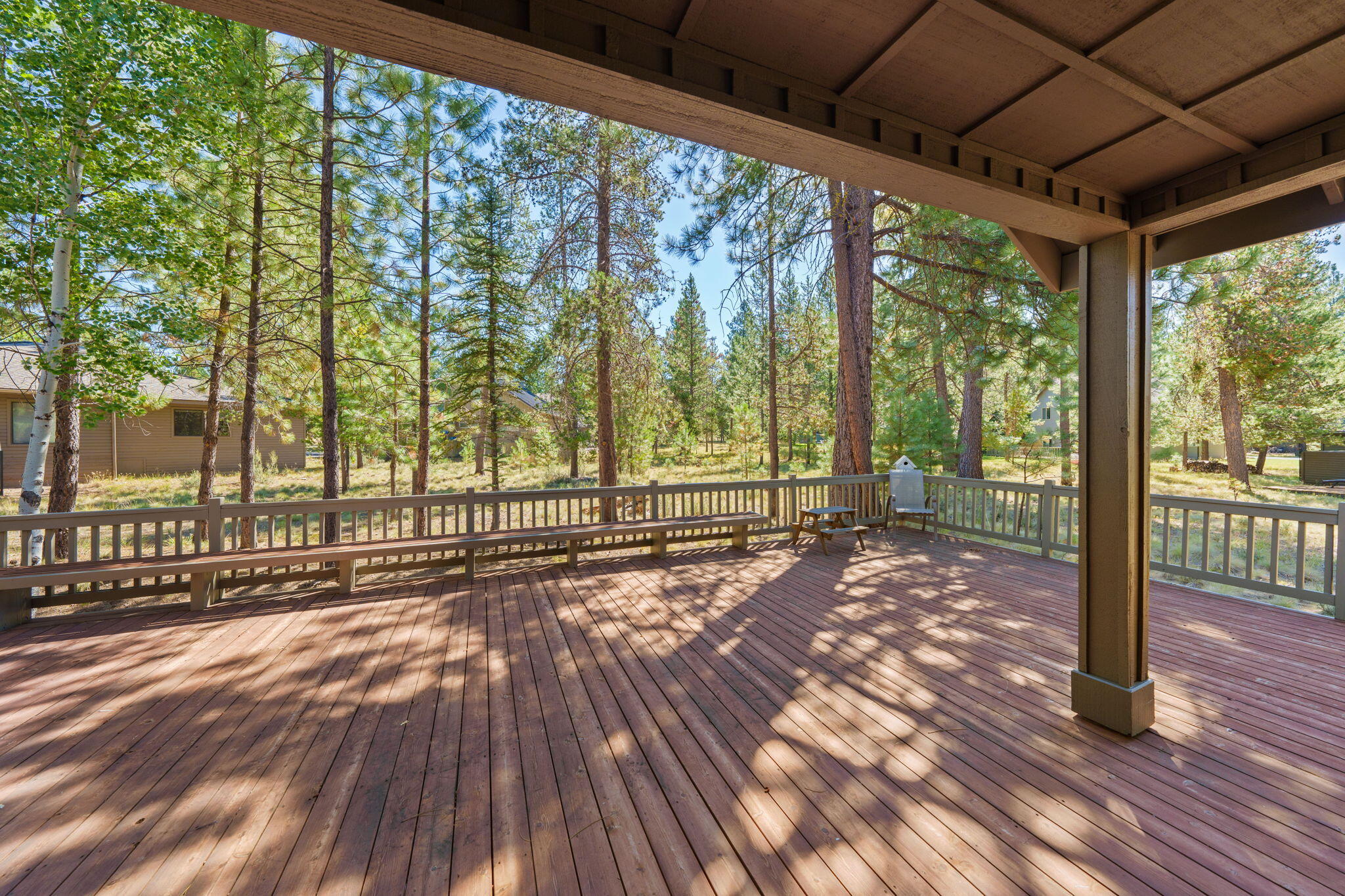 58026 Kinglet Road Sunriver, OR 97707 - Photo 32 of 39 a view of porch with a floor to ceiling window with wooden floor