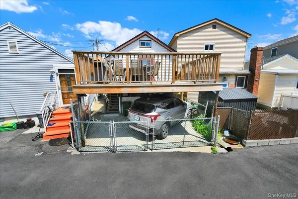 a view of a house with a yard and deck