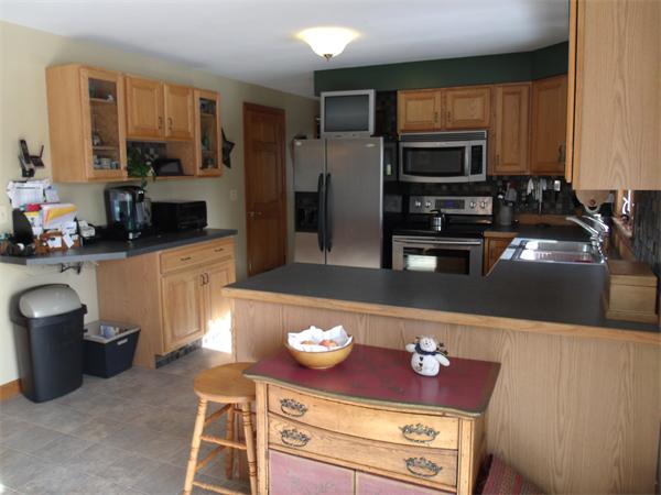 287 Wales Road Monson, MA 01057 - Photo 11 of 30 a kitchen with stainless steel appliances a stove a microwave and a refrigerator