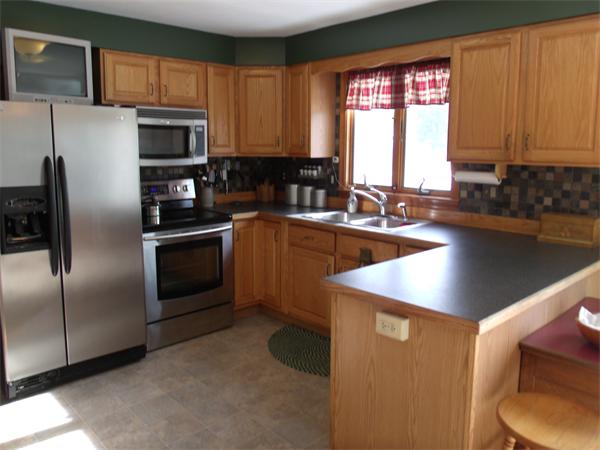 287 Wales Road Monson, MA 01057 - Photo 9 of 30 a kitchen with stainless steel appliances granite countertop a sink a stove and a refrigerator