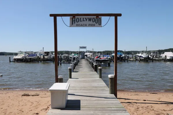 a wooden pier with boats and a lake view