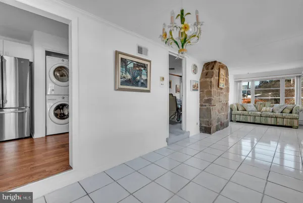 a view of a hallway with entryway and chandelier