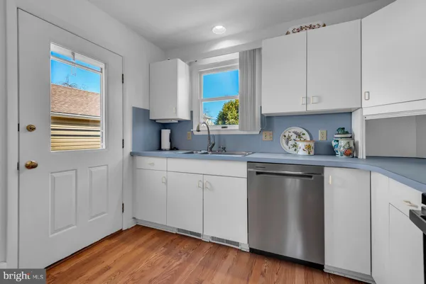 a kitchen with a sink cabinets and window