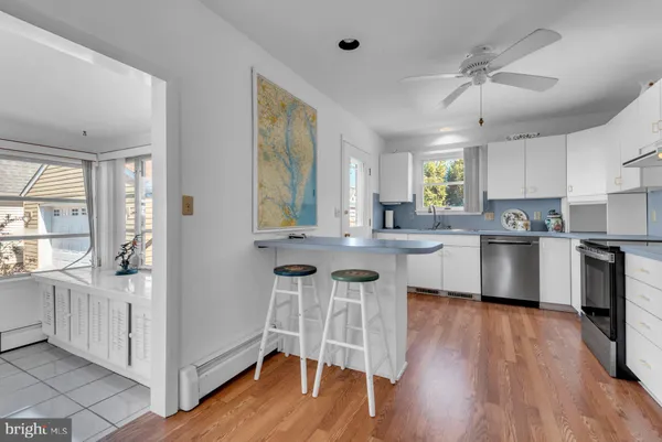 a kitchen with cabinets a sink a counter space and stainless steel appliances