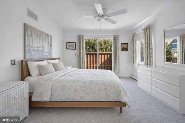 a large bed sitting in a bedroom next to a window