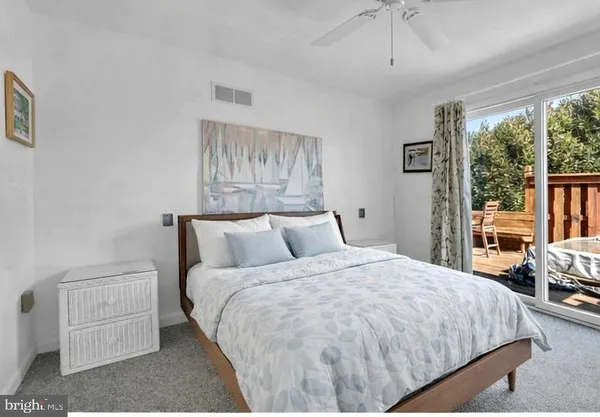 a large bed sitting in a bedroom next to a window