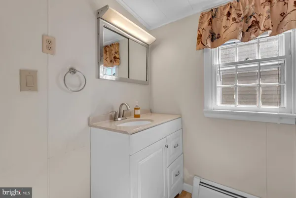 a utility room with a sink dryer and window