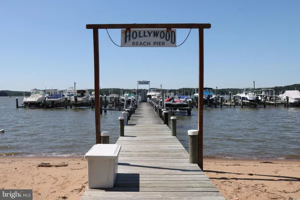 a wooden pier with boats and a lake view