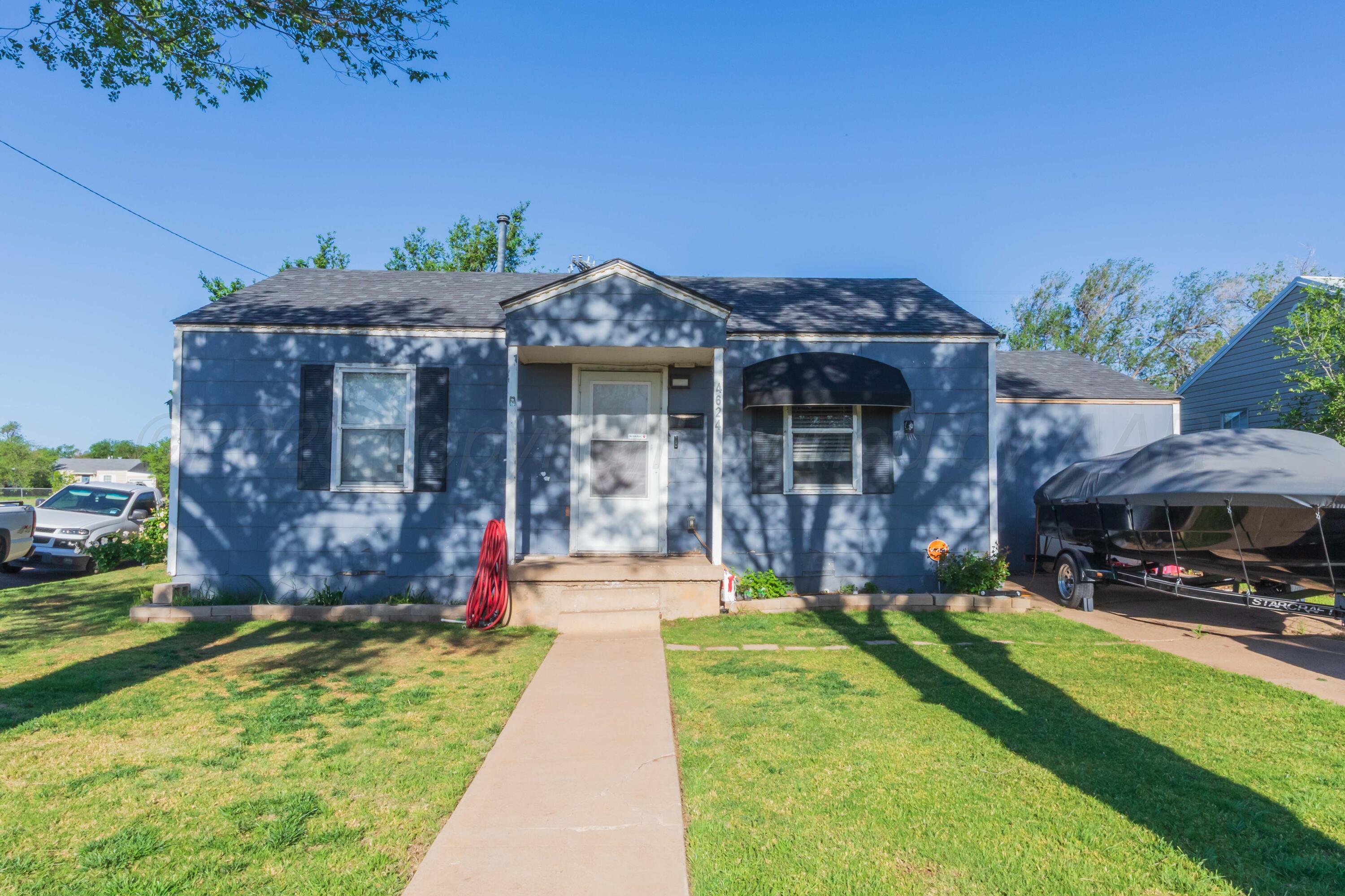 4624 South Travis Street Amarillo, TX 79110 - Photo 1 of 24 a front view of a house with a yard