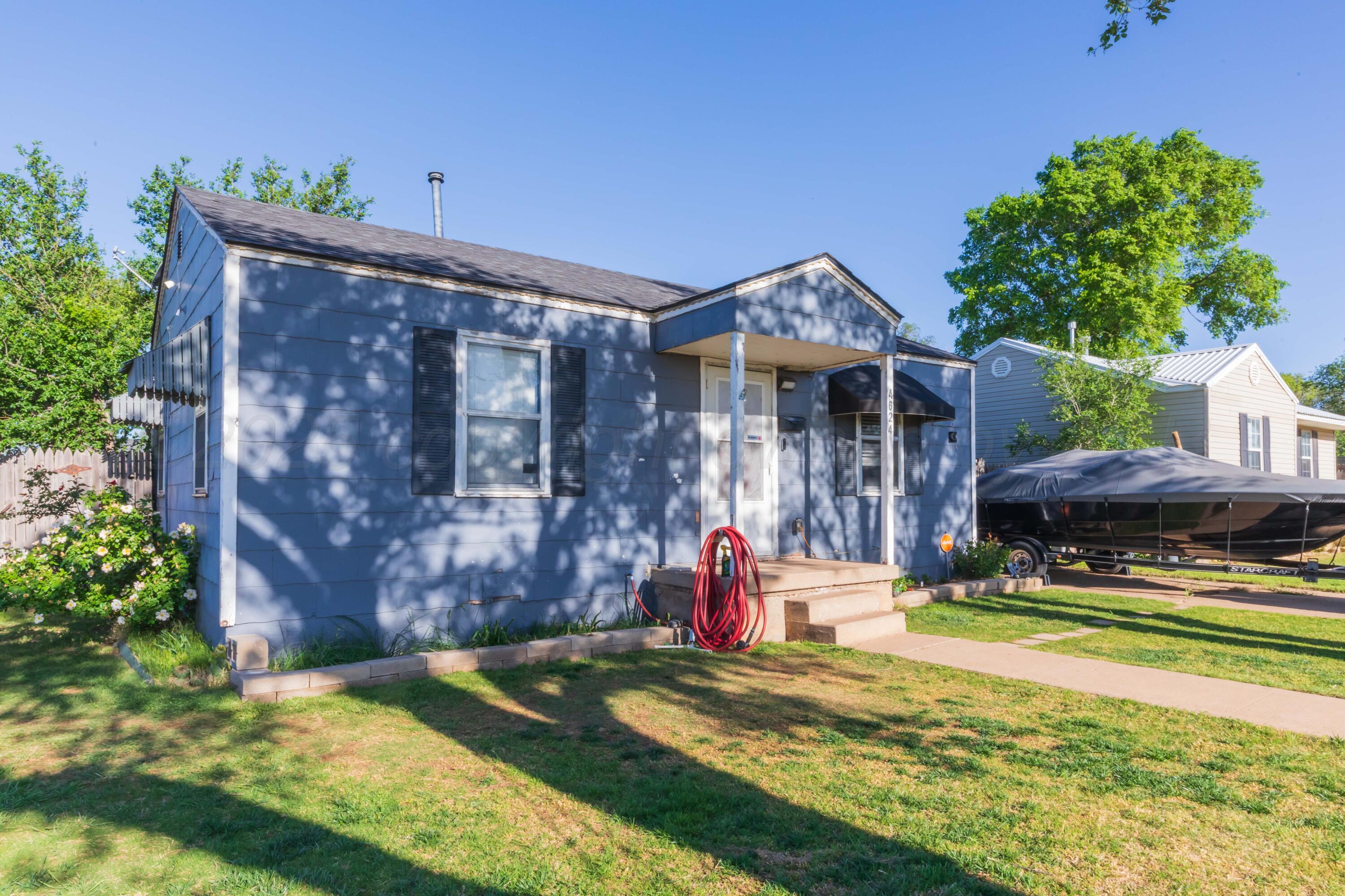 4624 South Travis Street Amarillo, TX 79110 - Photo 3 of 24 a front view of a house with garden