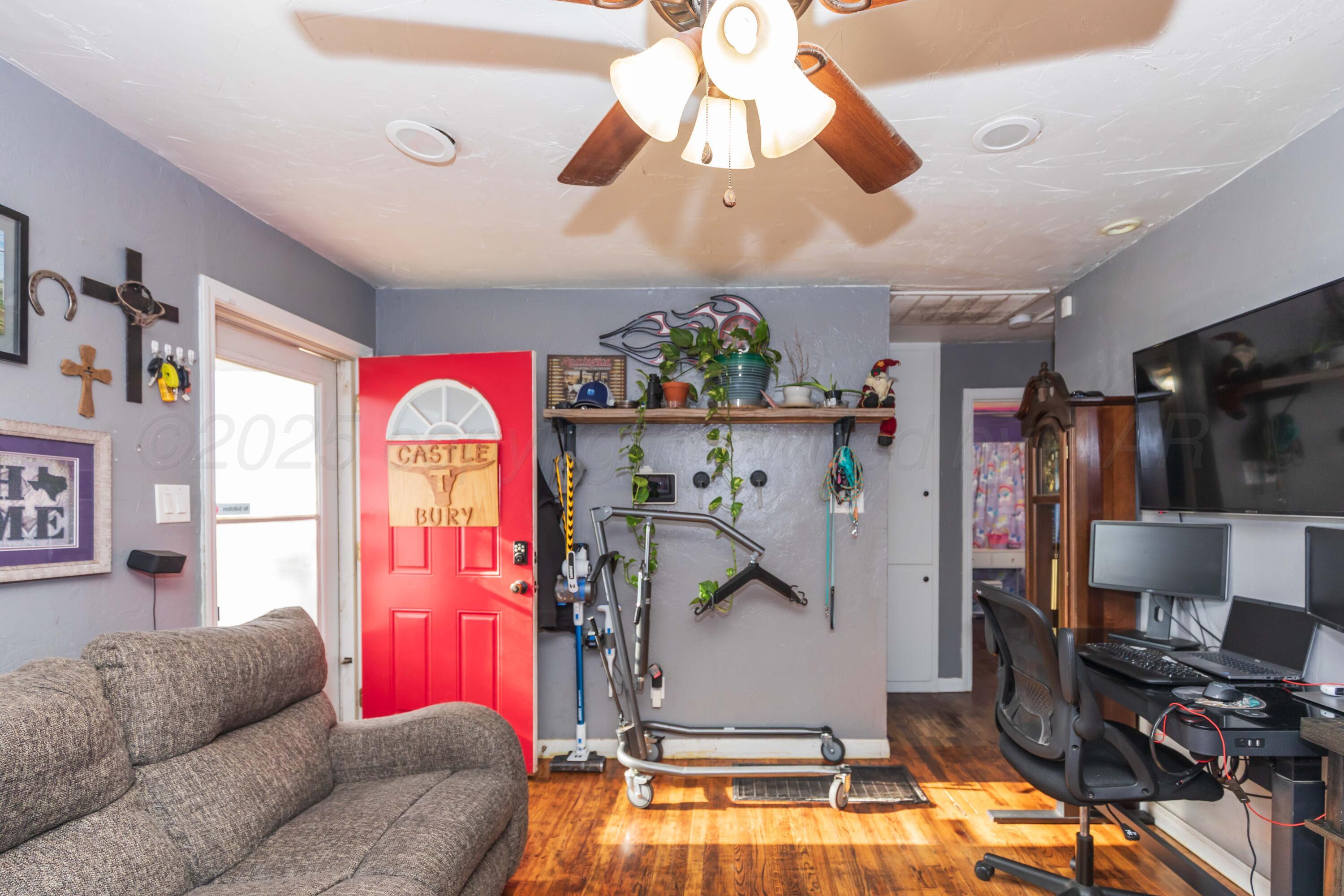 4624 South Travis Street Amarillo, TX 79110 - Photo 6 of 24 a living room with furniture and a flat screen tv