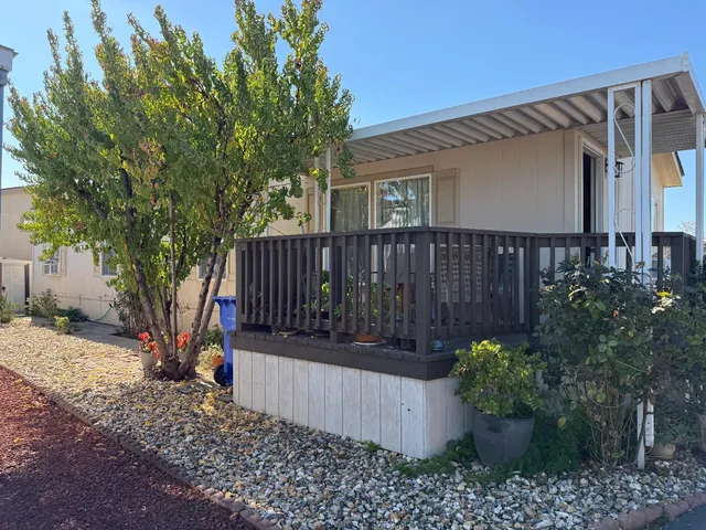 a view of a house with wooden fence