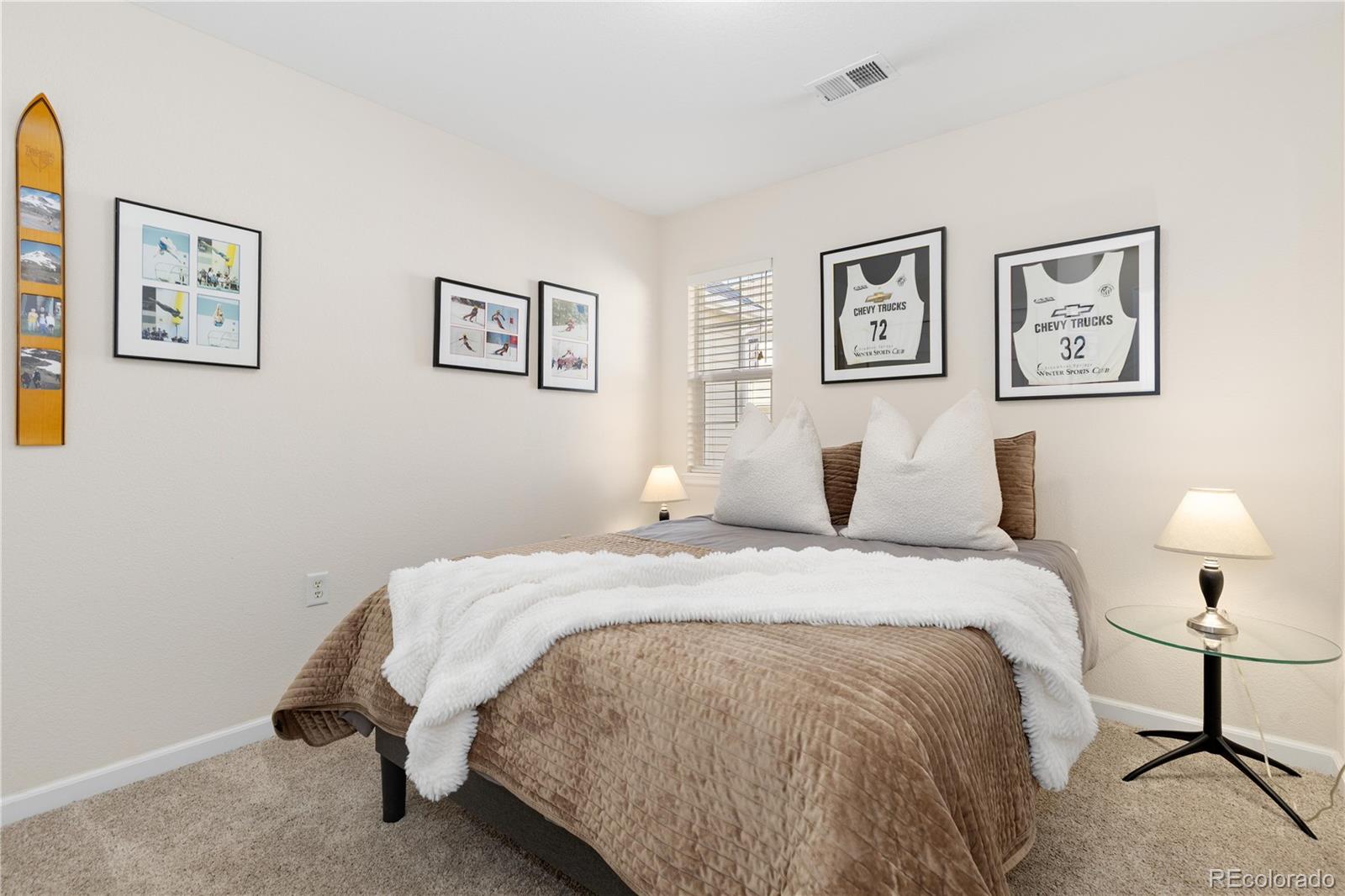 1468 Thunder Butte Road Castle Rock, CO 80109 - Photo 22 of 33 a bed room with a bed and painting on the wall