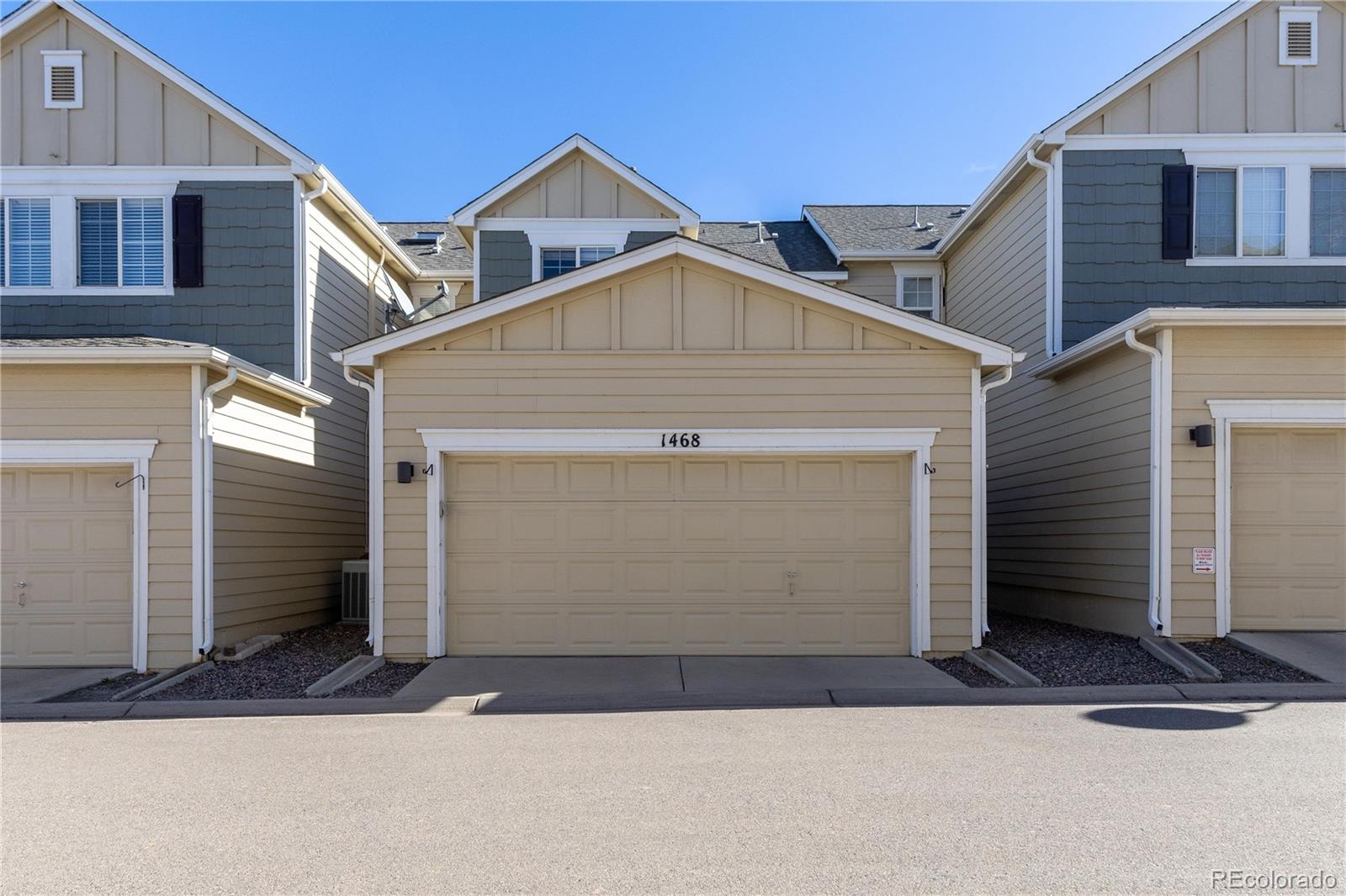 1468 Thunder Butte Road Castle Rock, CO 80109 - Photo 27 of 33 a front view of a house with a yard and garage