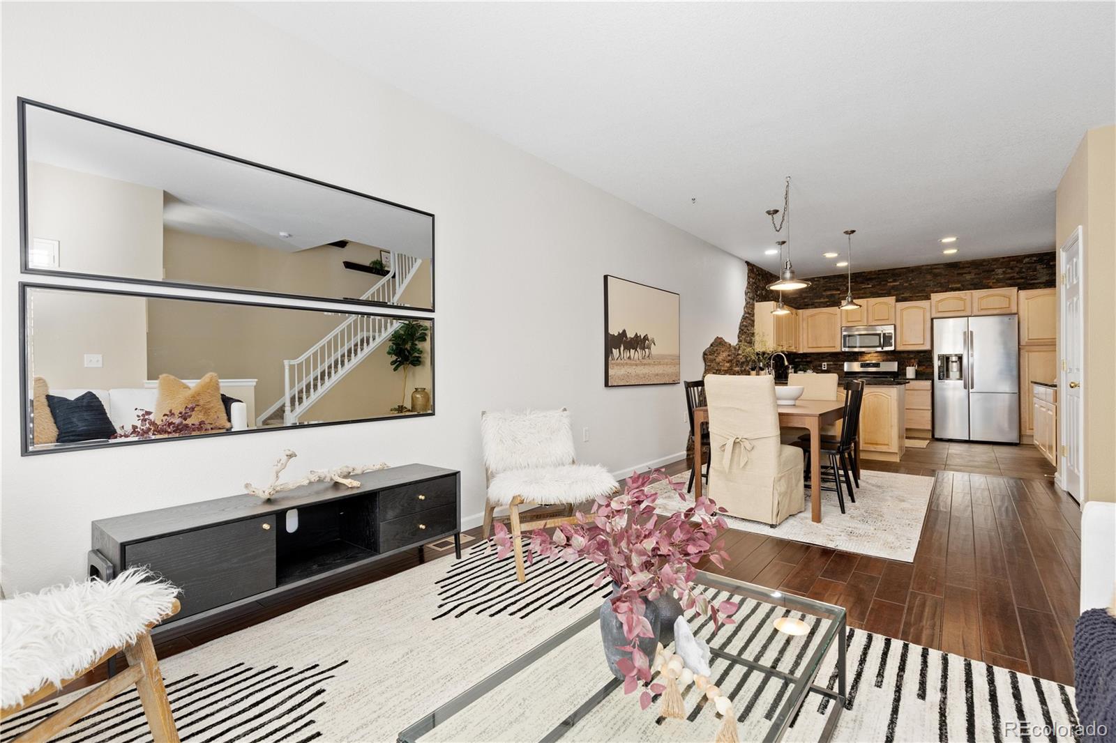 1468 Thunder Butte Road Castle Rock, CO 80109 - Photo 4 of 33 a living room with furniture a table and kitchen view