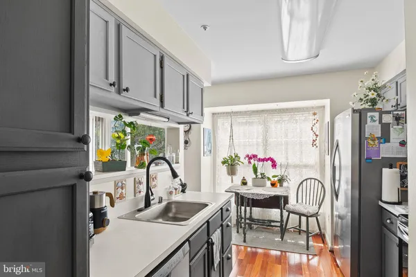 a view of a dining room with furniture a chandelier and large window