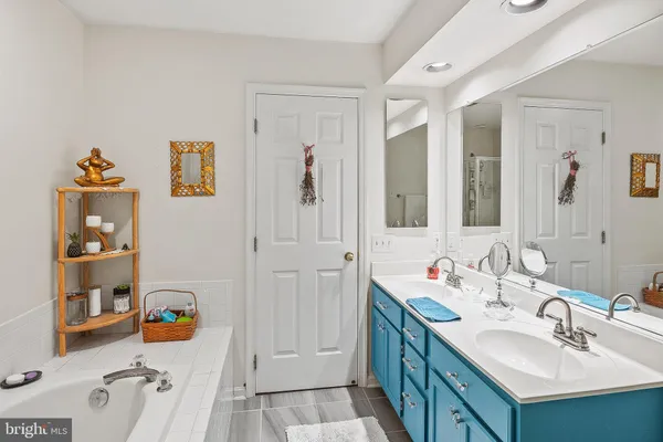 a bathroom with a sink mirror and shower