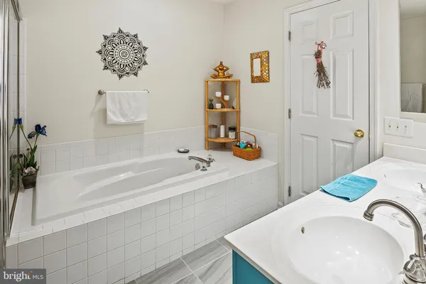 a bathroom with a tub and sink