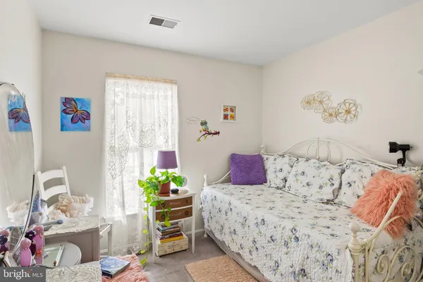 a bedroom with a bed and a couch