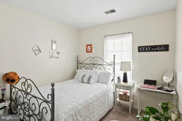 a bedroom with a bed and a table in it