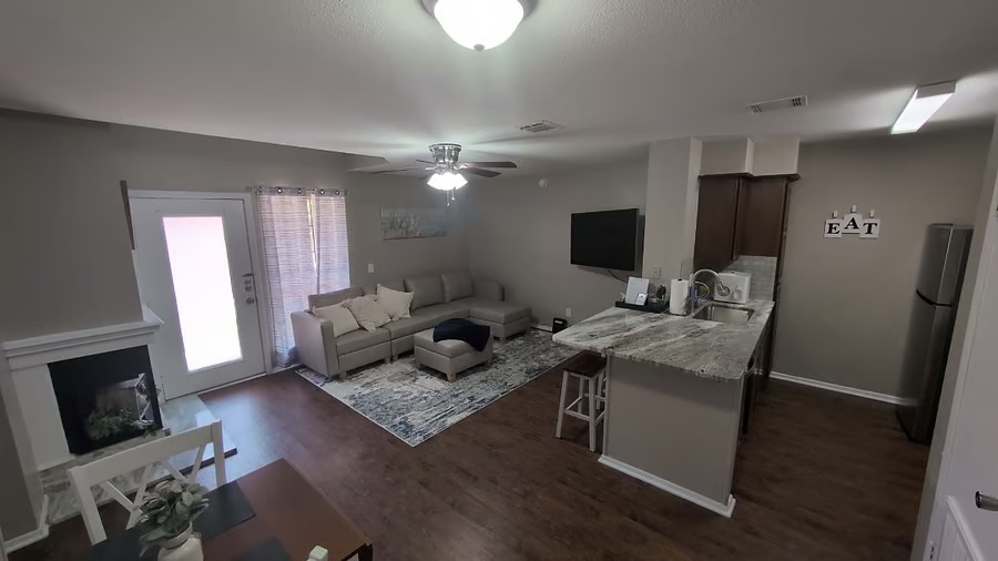 1305 West Villa Maria Road, Unit F104 Bryan, TX 77801 - Photo 3 of 9 a living room with furniture and a flat screen tv
