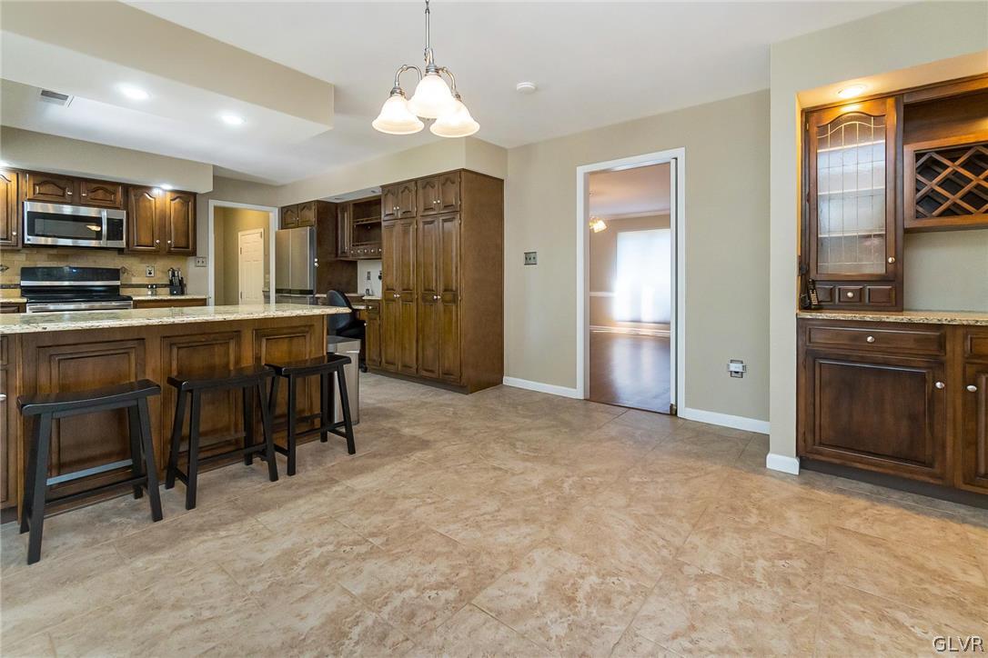 640 Macada Road Bethlehem, PA 18017 - Photo 14 of 48 a kitchen with stainless steel appliances granite countertop a refrigerator and a stove top oven